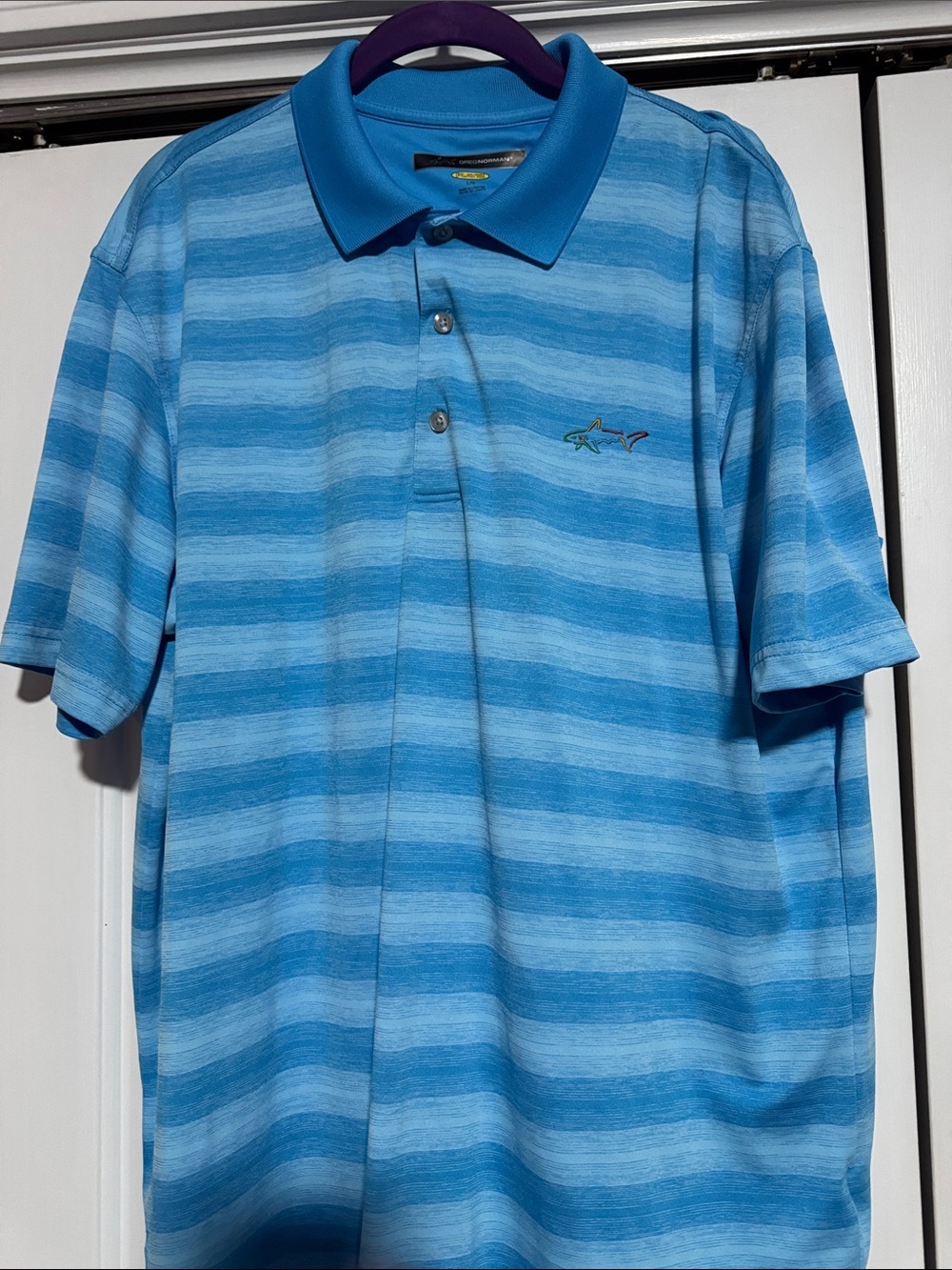 Greg Norman Collection Blue Striped Golf Polo with Shark Emblem